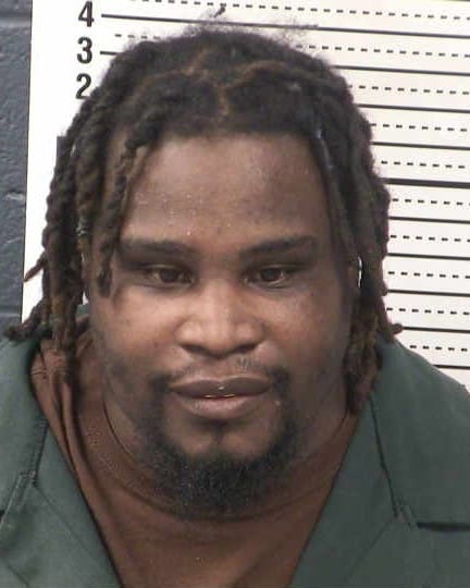 Mugshot of Orangie Lee Fisher, 37, showing head and shoulders in front of a height chart.
