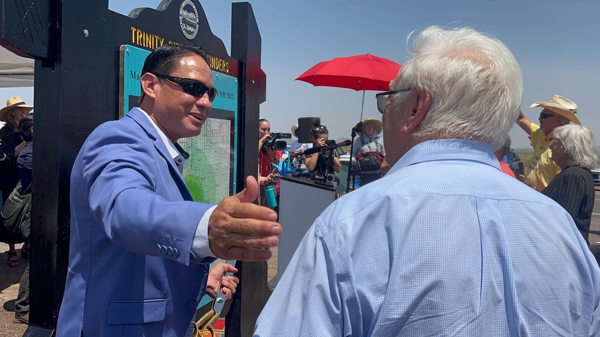 Lt. Gov. Howie Morales greets an attendee at a RECA celebration and Trinity Test anniversary event near White Sands.