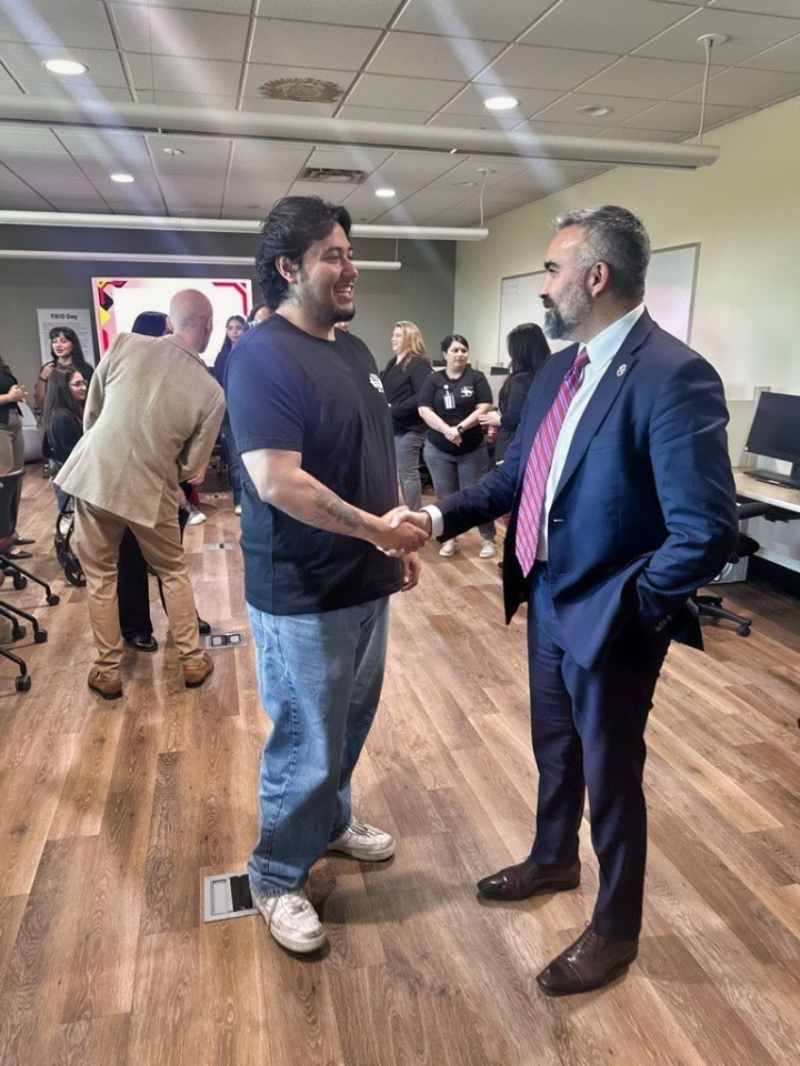 Attorney General Raúl Torrez shakes hands with a TRIO student inside a New Mexico Junior College classroom during a campus visit in Hobbs.