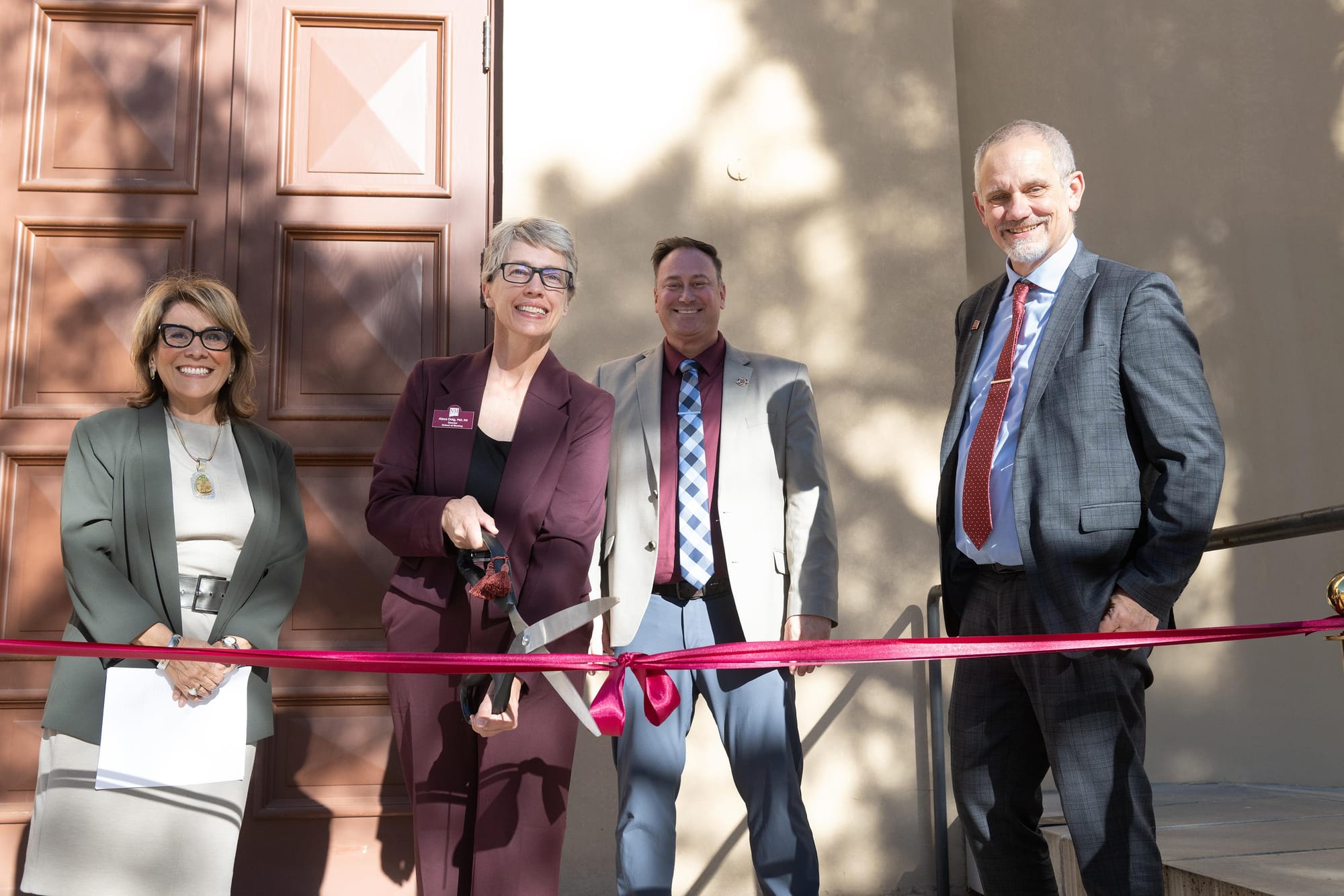 Alexa Doig, director of the NMSU School of Nursing, cuts a ceremonial ribbon alongside other NMSU leaders during the opening of the university’s new simulated operating room.