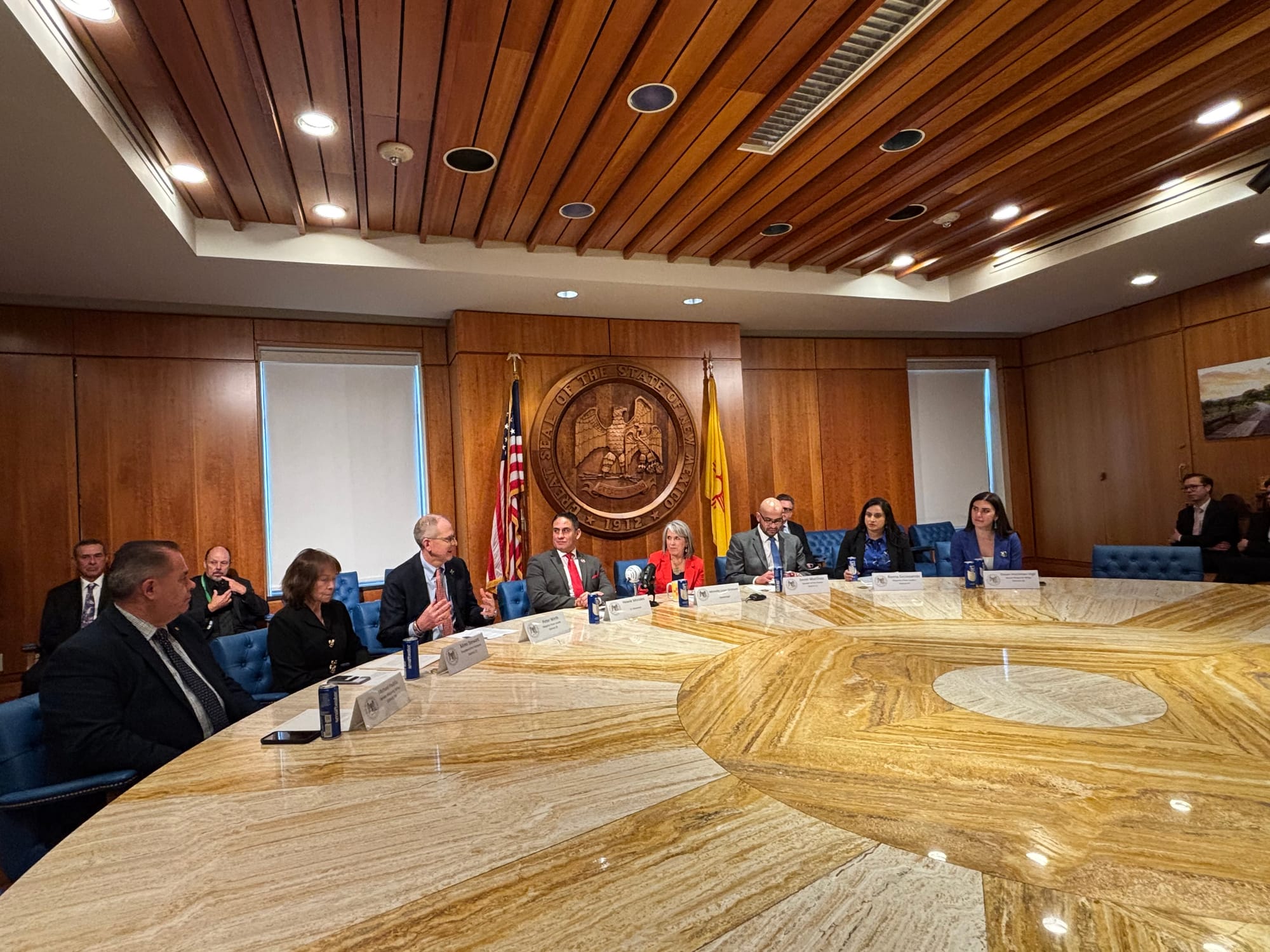 New Mexico Gov. Michelle Lujan Grisham and Democratic legislative leaders sit around a large conference table during a Feb. 19 news conference at the Roundhouse in Santa Fe.