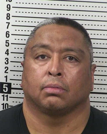 Mugshot of Felipe Hernandez taken against a height chart background.