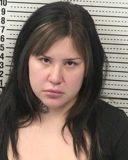 Booking photo of Kayla Renee Salcido against a height chart background.
