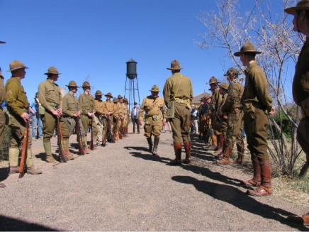 Historical reenactors in early 20th-century military uniforms line a pathway during Camp Furlong Day festivities at Pancho Villa State Park in Columbus.