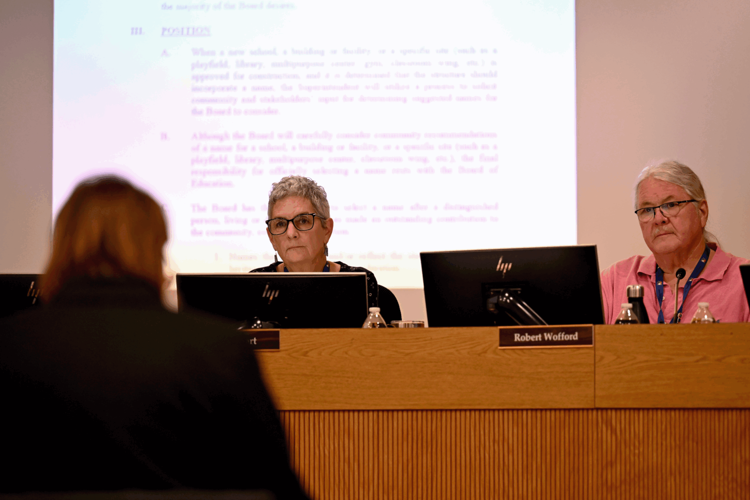 Las Cruces Public Schools Board of Education President Pamela Cort and Vice President Robert Wofford sit at a dais during a March 24, 2026, meeting discussing renaming César Chávez Elementary