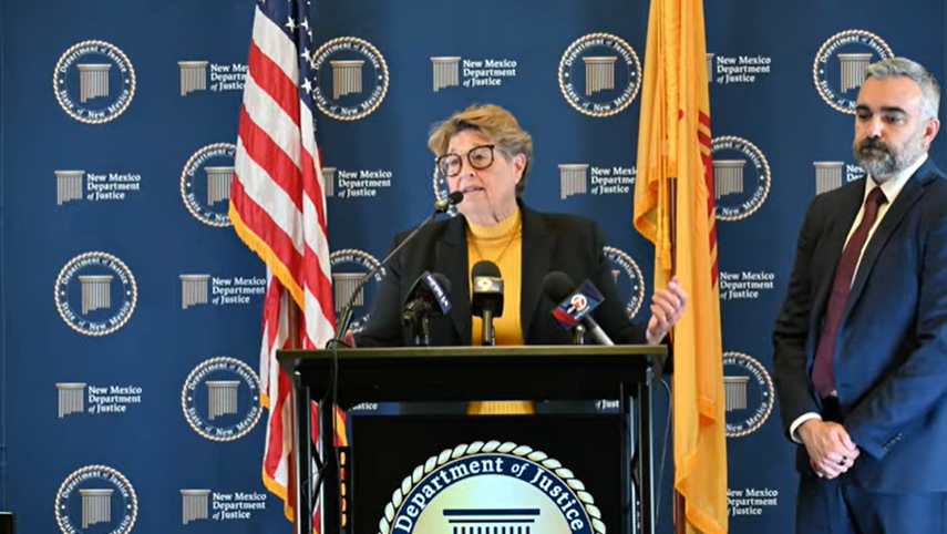 Doña Ana County Sheriff Kim Stewart speaks at a podium during a press conference while Attorney General Raúl Torrez stands beside her.