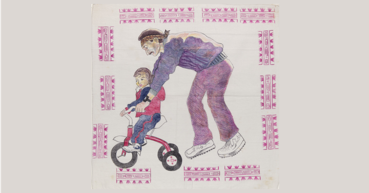 Drawing on a white handkerchief showing a man helping a child ride a tricycle, surrounded by pink geometric border designs.