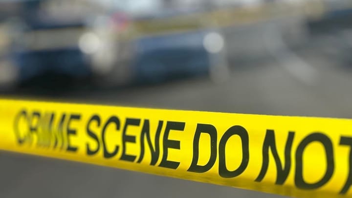 Yellow crime scene tape marks off an area as police investigate.