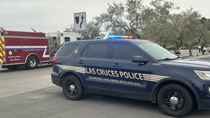 A Las Cruces Police Department SUV blocks a road near Salopek Park as an LCPD officer and a fire engine from Las Cruces Fire Department are seen in the background at an active scene.