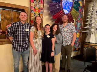 Five newly hired veterinarians in Las Cruces standing together at a welcome event.