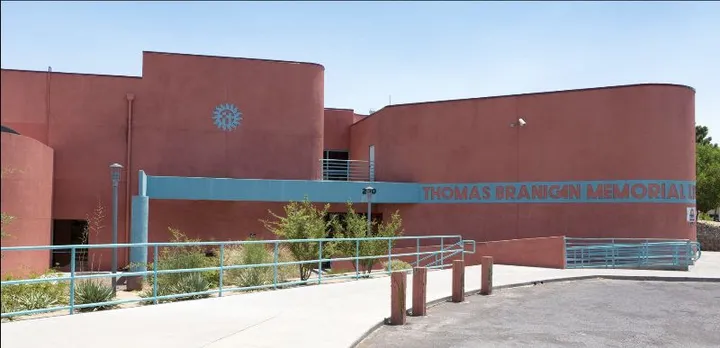 Thomas Branigan Memorial Library in Las Cruces, New Mexico, with its curved adobe-style architecture and turquoise railings.
