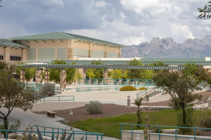 Doña Ana Community College campus with the Organ Mountains visible in the background and landscaped walkways in the foreground.