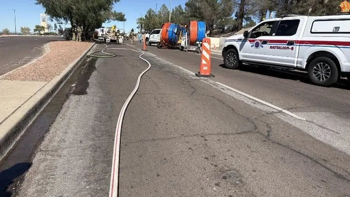 Fire hose stretched across South Telshor Boulevard as Las Cruces Fire Department and utility crews respond to a gas leak near Foothills Road.