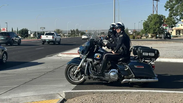 Two Las Cruces police officers on motorcycles watch traffic during a Thursday morning enforcement operation on Main Street.