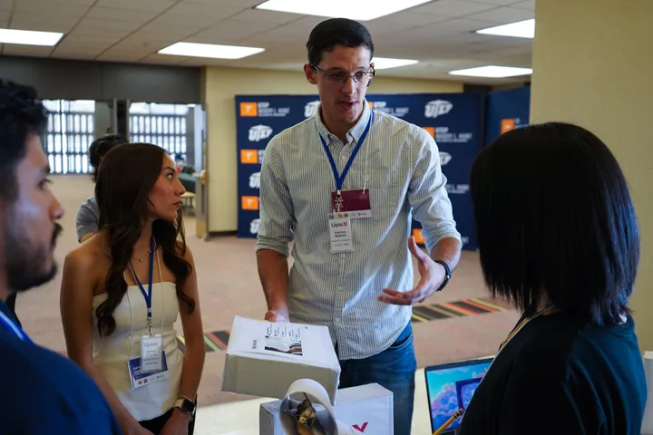 New Mexico State University student Hamzah Badarani discusses his team’s project with judges during the Negotium 2025 binational business competition at the University of Texas at El Paso.