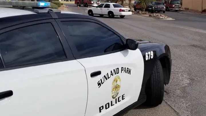 A Sunland Park Police Department patrol vehicle is parked on a residential street as other emergency vehicles respond in the distance.