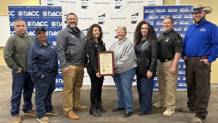 Doña Ana County and Doña Ana Community College officials stand together indoors holding a signed memorandum, marking a new water technology internship partnership.