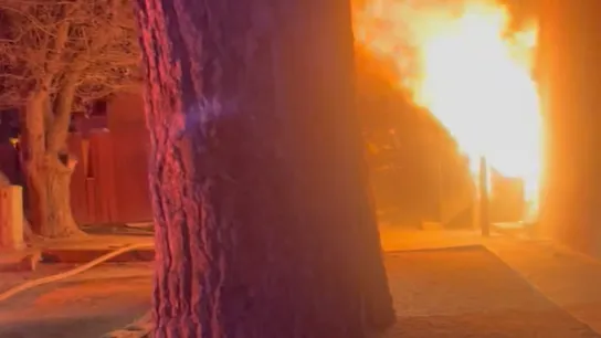 Flames engulf an apartment unit at night as firefighters respond to a structure fire on West Madrid Avenue in Las Cruces.