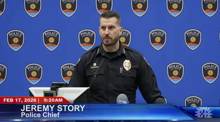 Las Cruces Police Chief Jeremy Story speaks at a podium during a Feb. 17, 2026 news conference about the Feb. 8 fatal police shooting, with a department logo backdrop behind him.