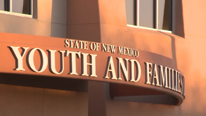 Sign on a state building reading “State of New Mexico Youth and Families Department.”