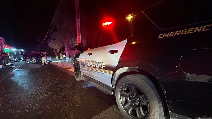 A Doña Ana County Sheriff’s Office patrol unit with emergency lights activated is parked on a roadway at night as deputies respond to an incident scene.